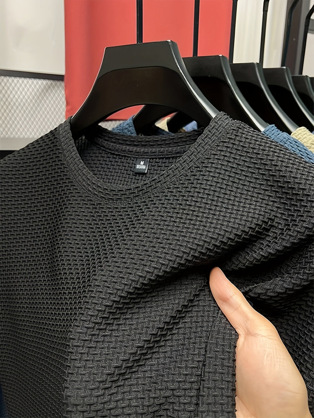 Men's textured knit crew neck T-shirt on a hanger