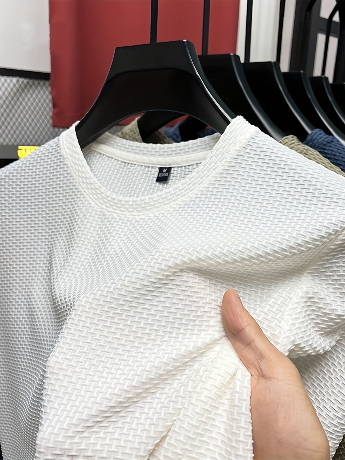 Men's textured knit crew neck T-shirt on a hanger
