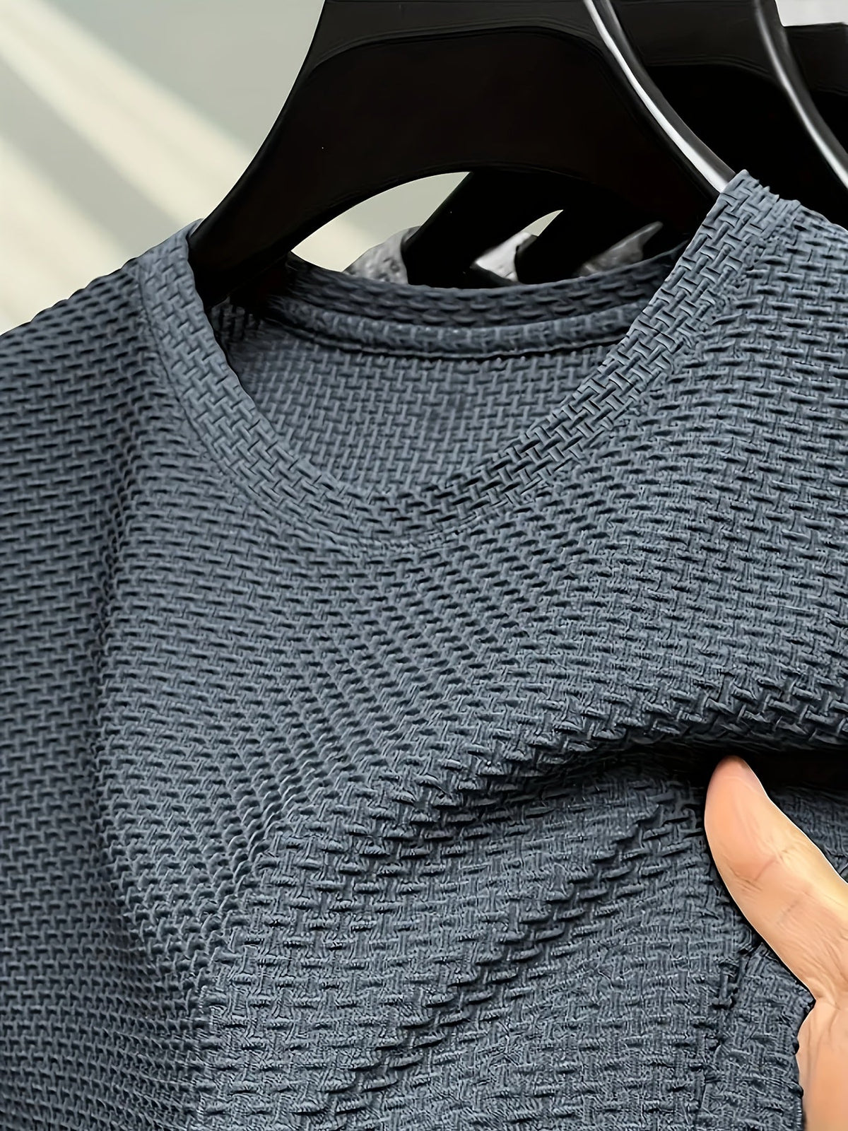Men's textured knit crew neck T-shirt on a hanger
